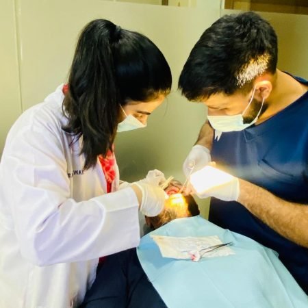 dentists examining patient in dental clinic